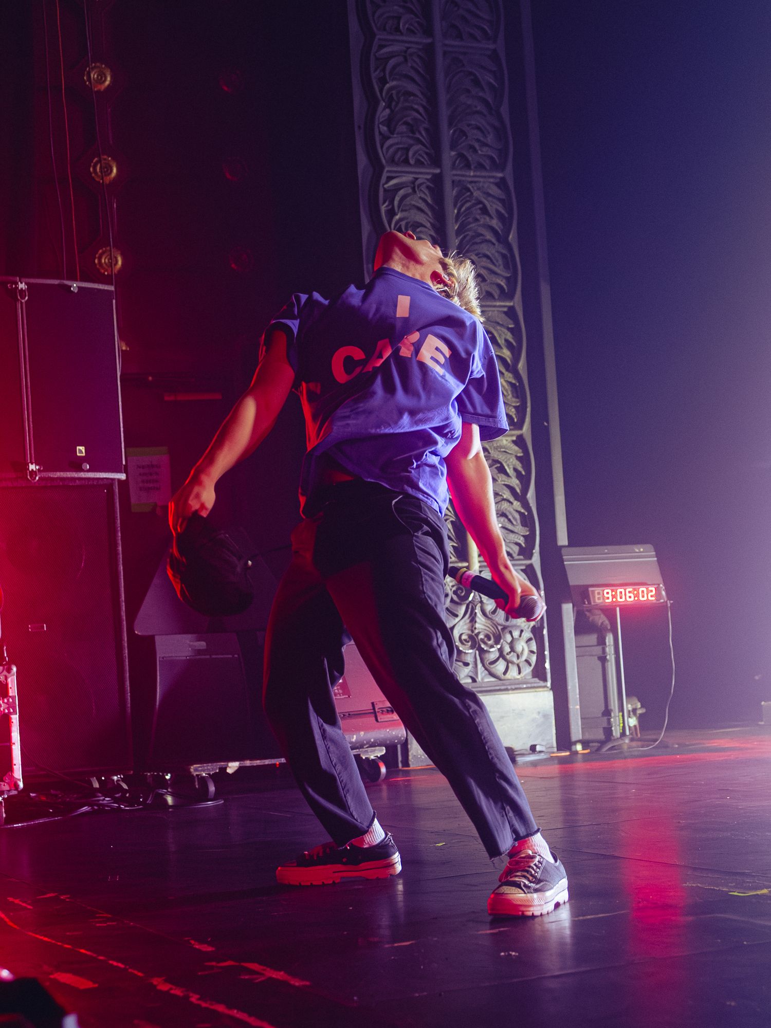 Dancer performs dynamic moves on stage with red and purple lighting creating dramatic silhouettes in sequence.
