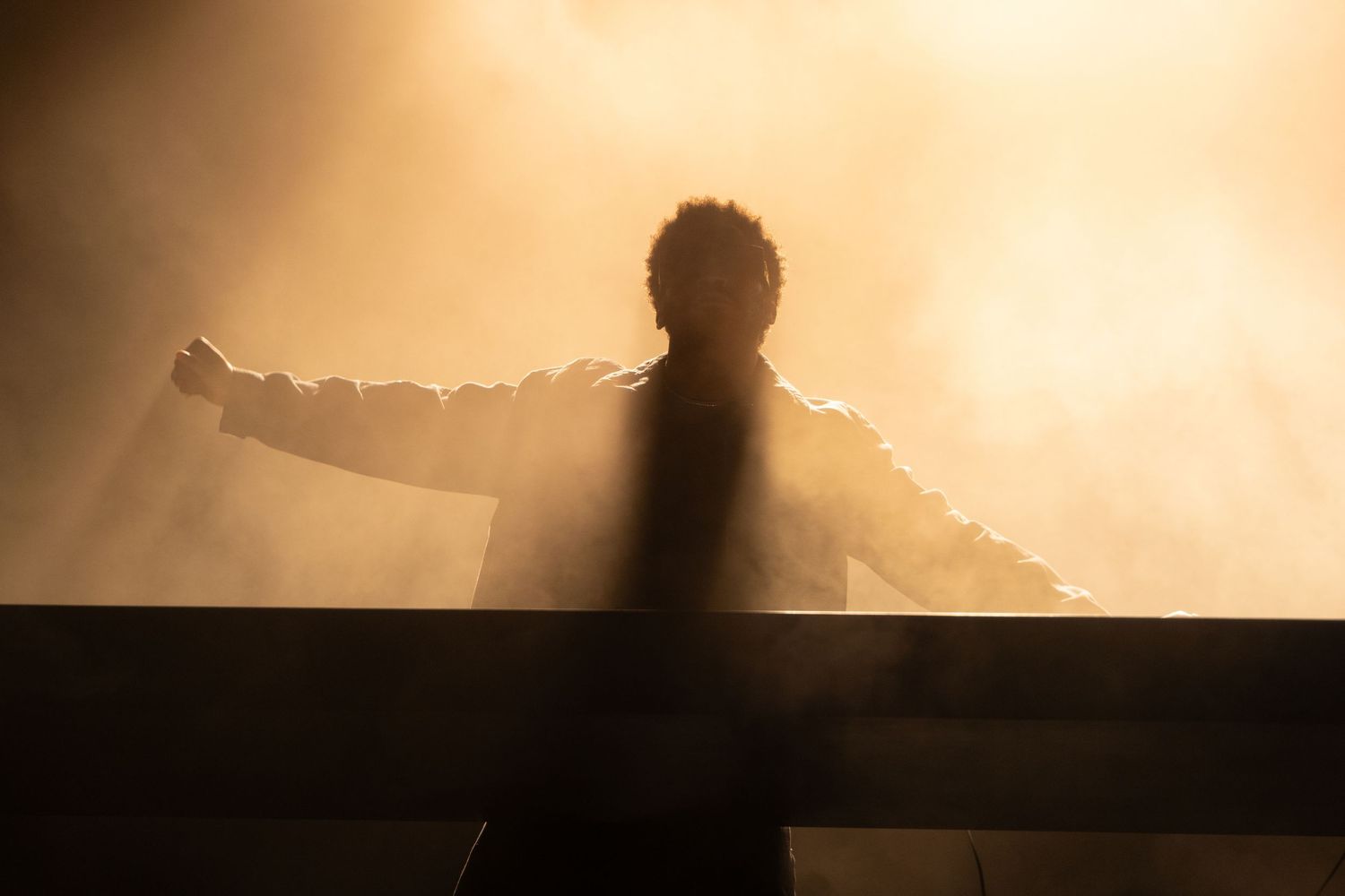 Dramatic sunset silhouette against orange sky creates moody atmospheric backdrop.