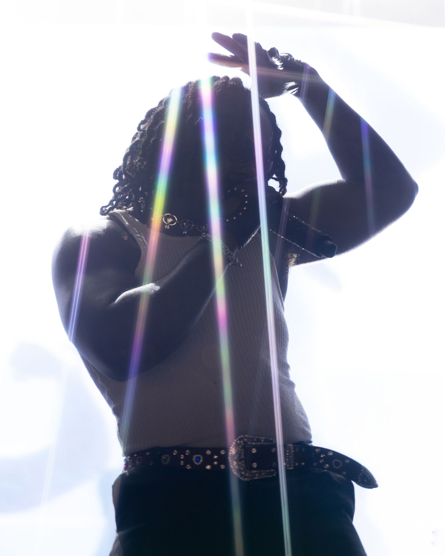 Silhouettes of performers against bright backlit stage lighting.