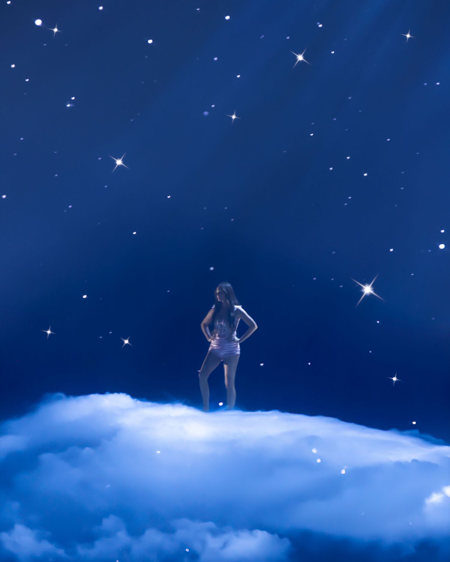 Ethereal figures standing on clouds against a starry blue night sky backdrop.