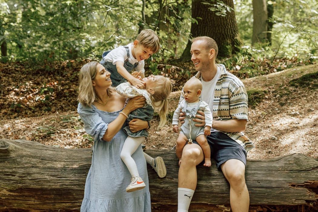 A relaxed family portrait - a brother tickles his sister as they play in Marlow Common.