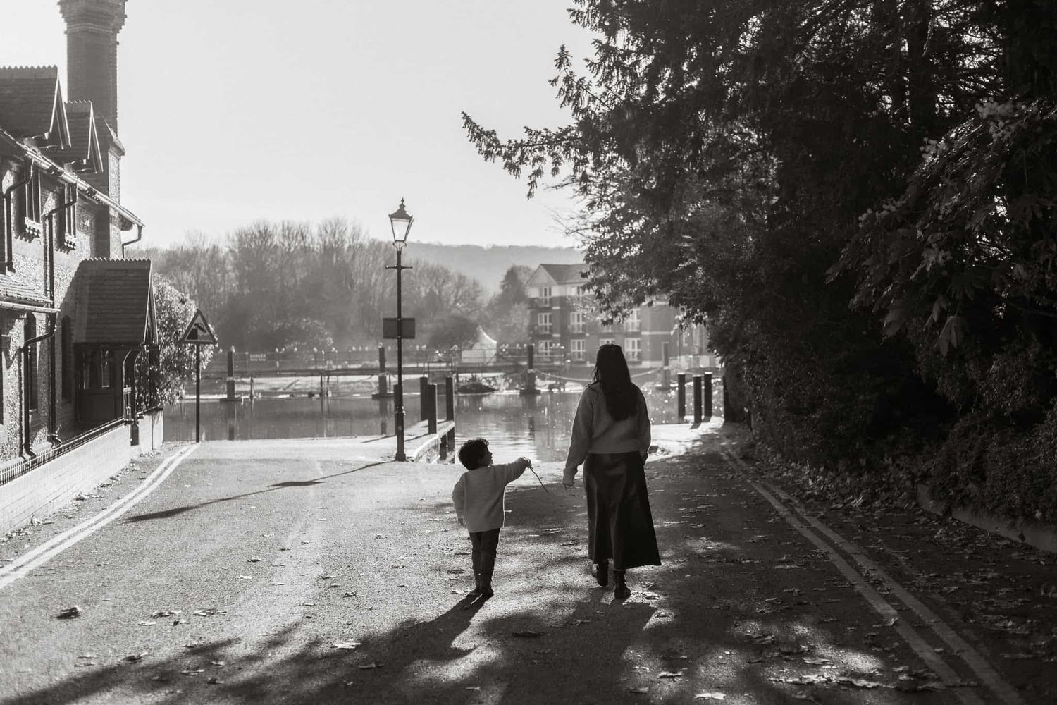 A mother and son walk down St Peter St to the river in Marlow on a family photo session.