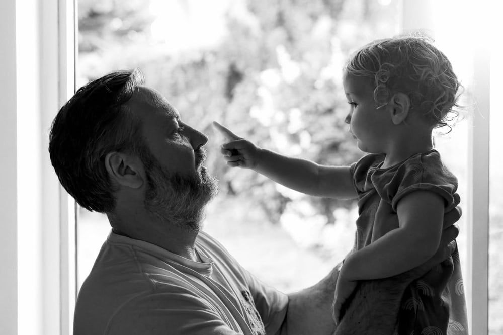 A father holding his young song at home in Marlow.