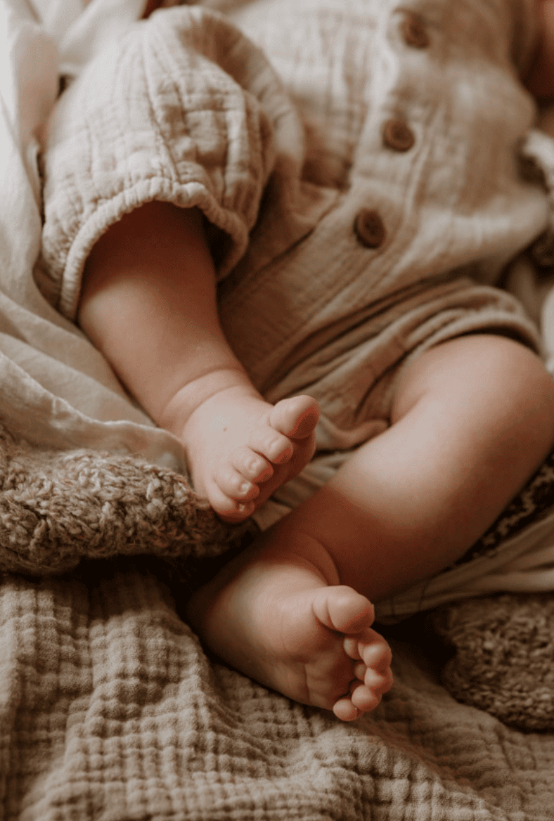 A photograph of baby's sweet feet and legs, taken in Marlow, Bucks, at a baby photo shoot.