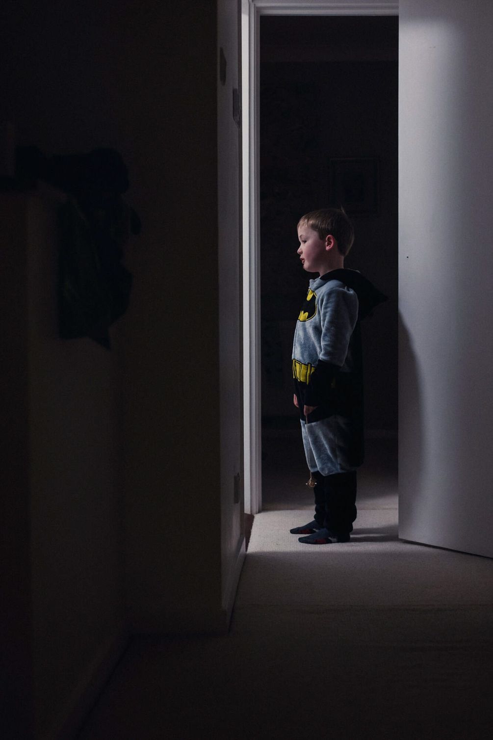 A young boy in a batman costume.