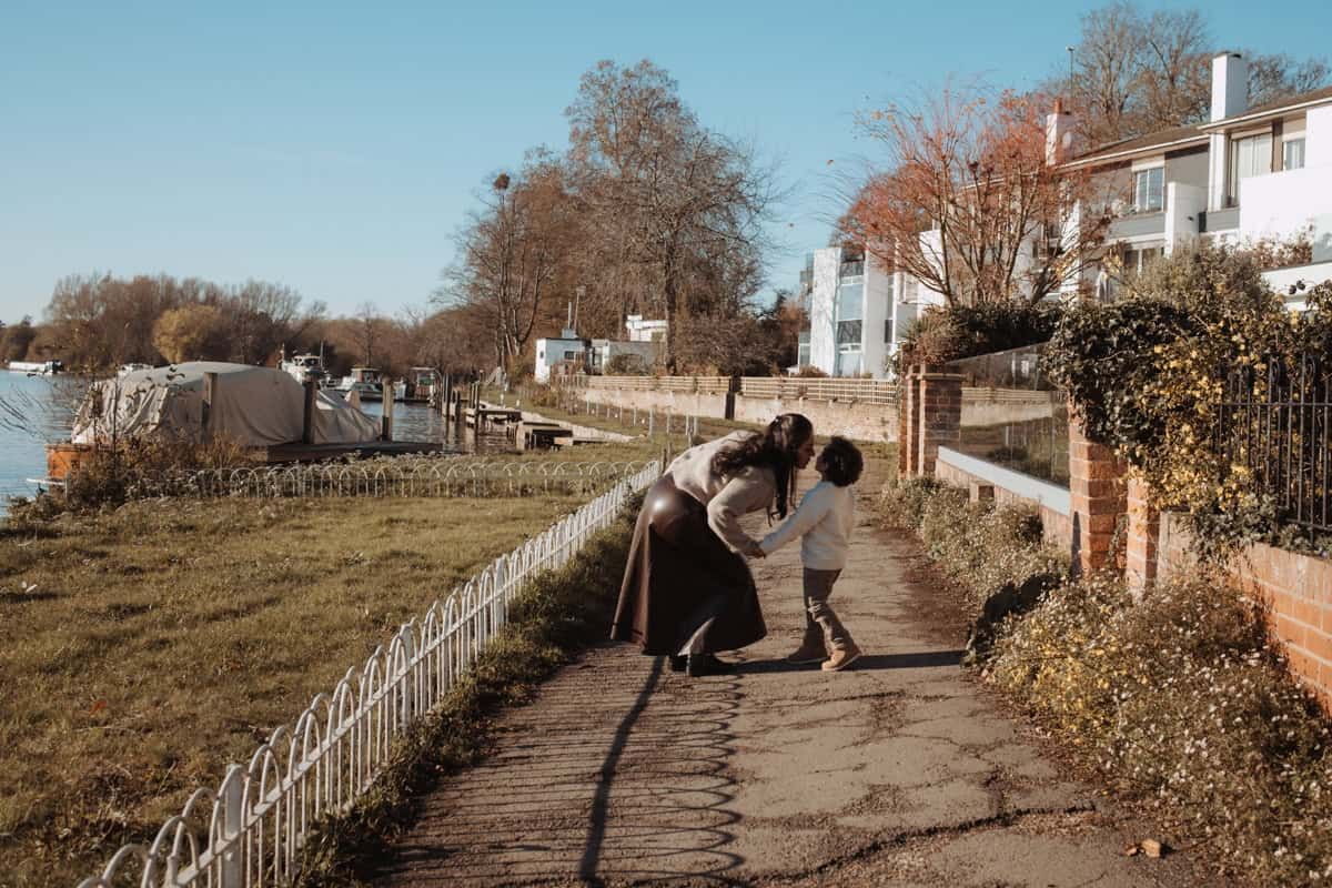 A mother kisses her young son on a pathway in the park in Marlow.
