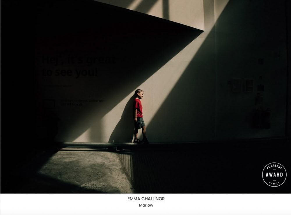 A boy stands in a sfhaft of light at Ikdea in Reading.