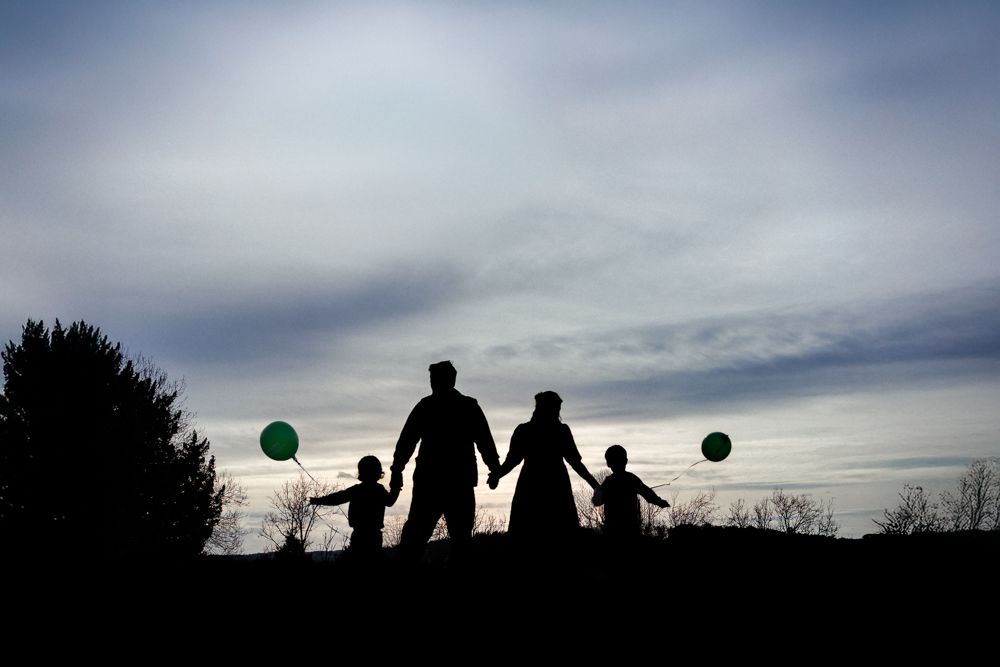 A silhouette family portrait, taken on the top of West Wycombe Hill.