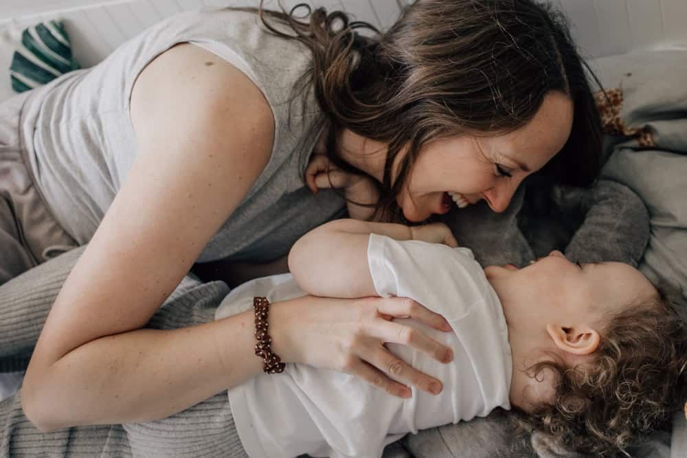 A mother and her daughter in the middle of a tickle fight!