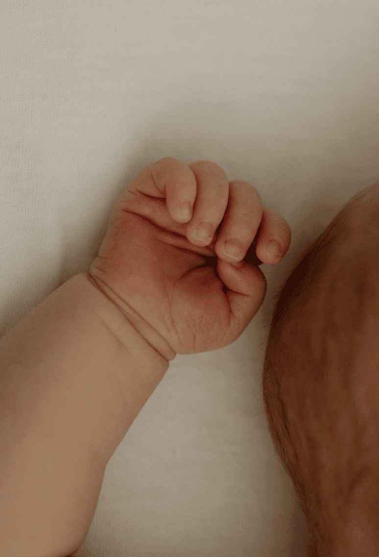 An image of a baby's little hand- capturing these little newborn details is a key aspect of my baby photo sessions.