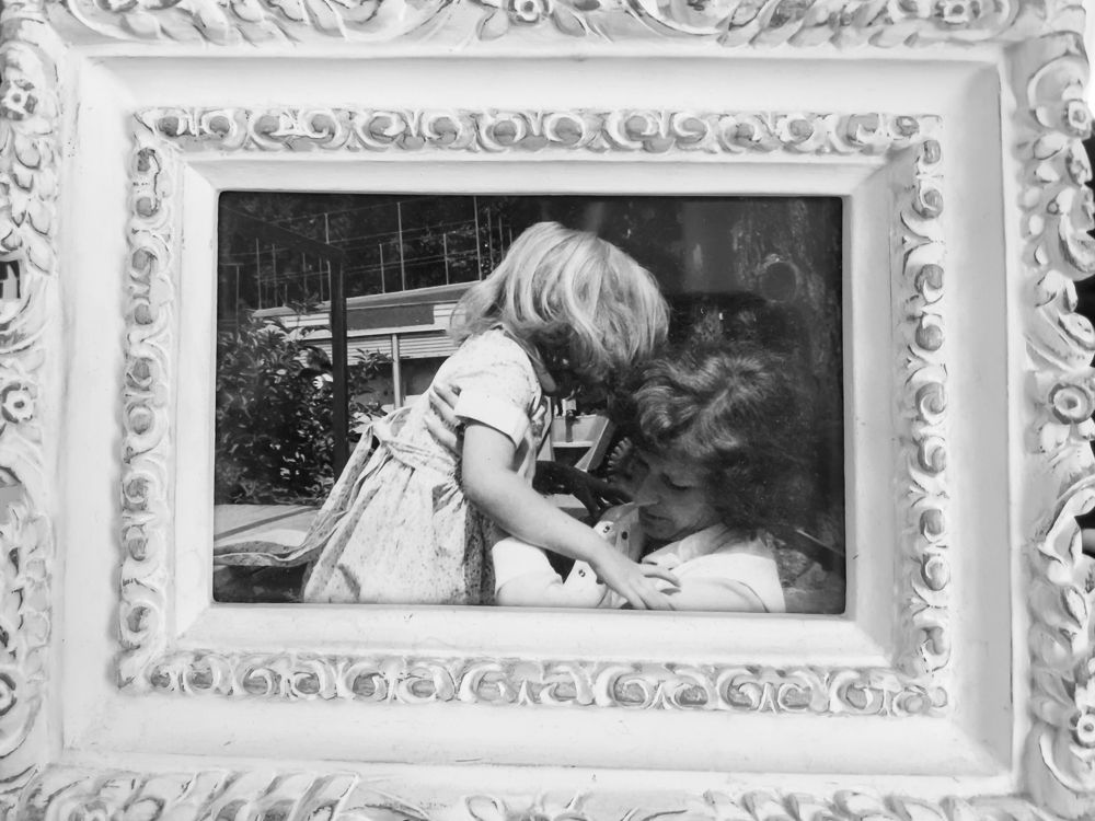 Me and my Mum- a simple black and white image of her reaching out to pick me up that is framed in my bedroom.