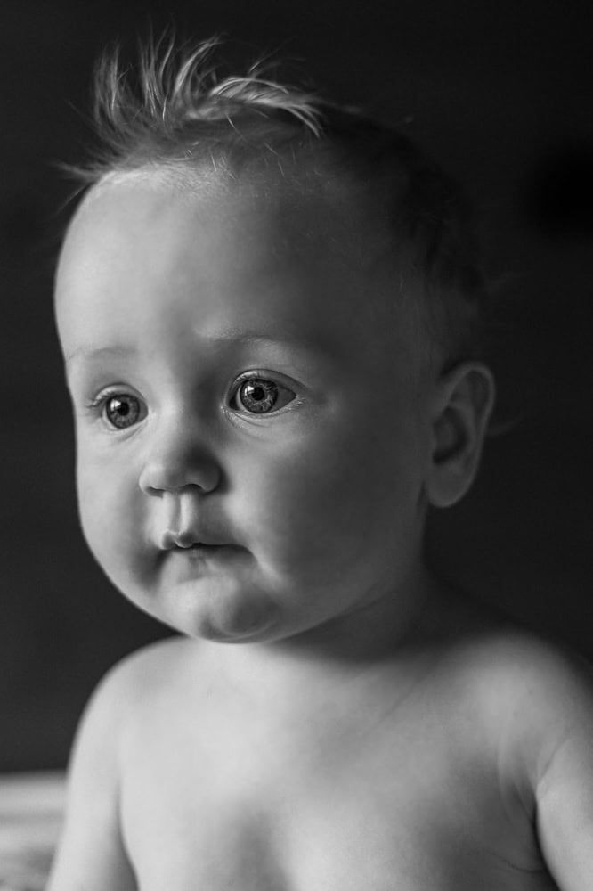 A black and white portrait of a young boy.