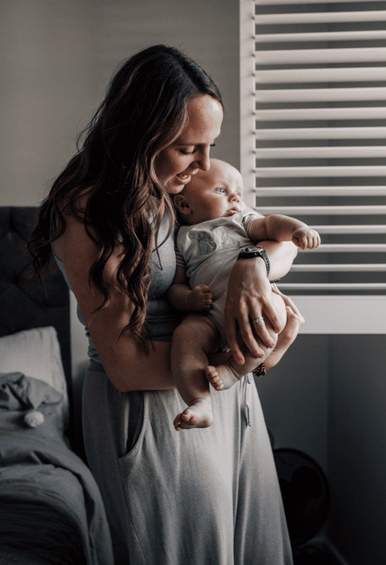 A mother holds her 4-month-old.