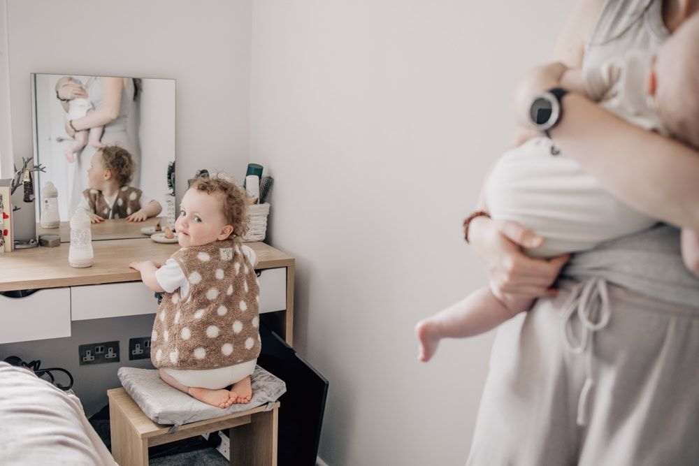 A mum with her toddler and baby at an in-home session in Marlow.