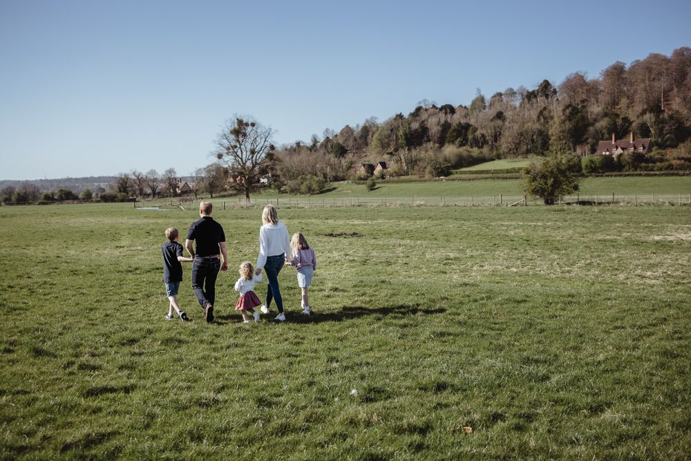 A family of five walk away from the camera in Hambleden.