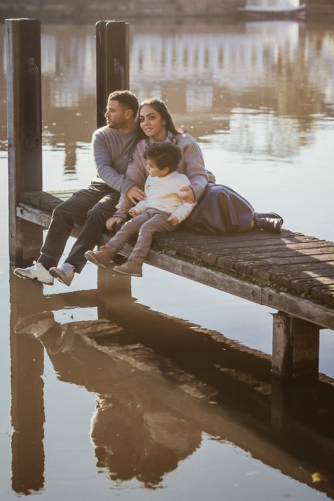 A family sit on the jetty at the end of St Peter's Street in Marlow.