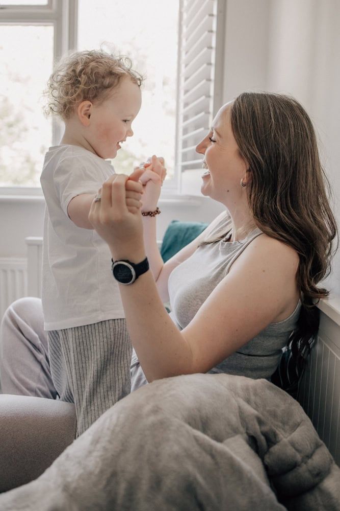 A Mum holds hands with her two-year-old daughter at home in Marlow.