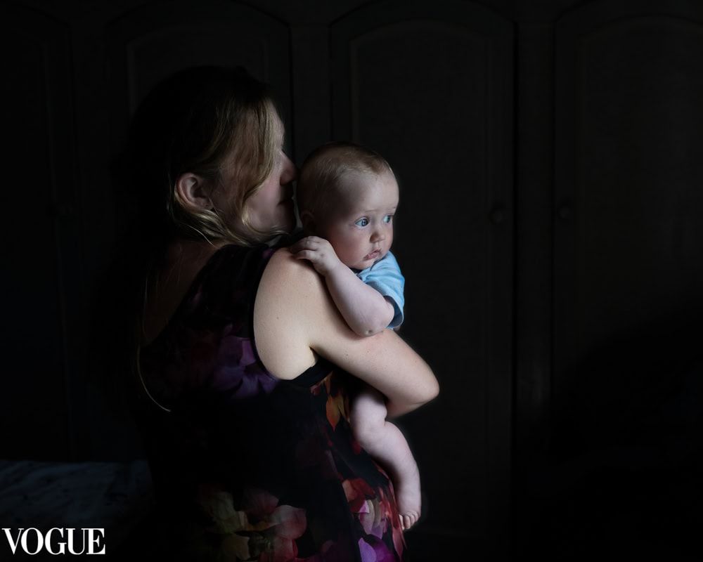 A mother holds her baby at home in Dorney.