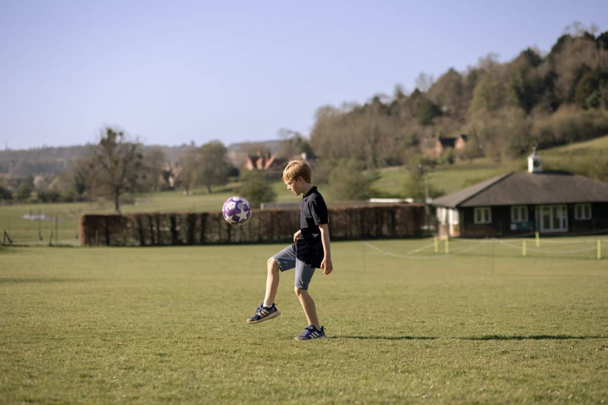 A boy playing football.