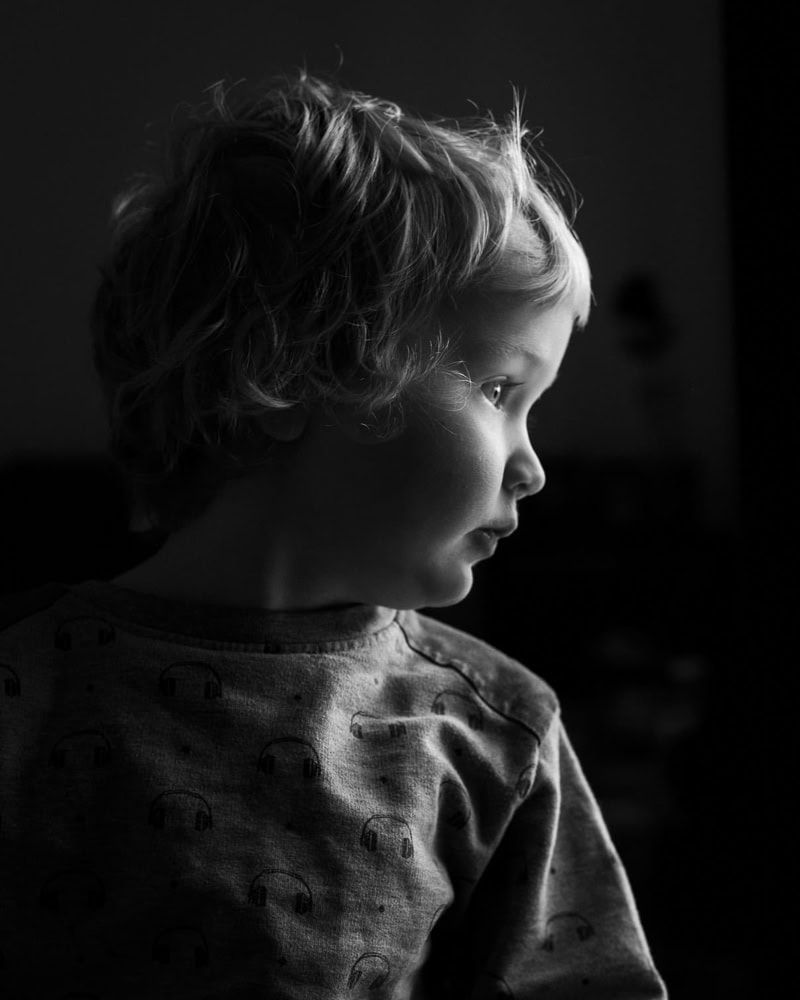 A low key portrait of a young boy.