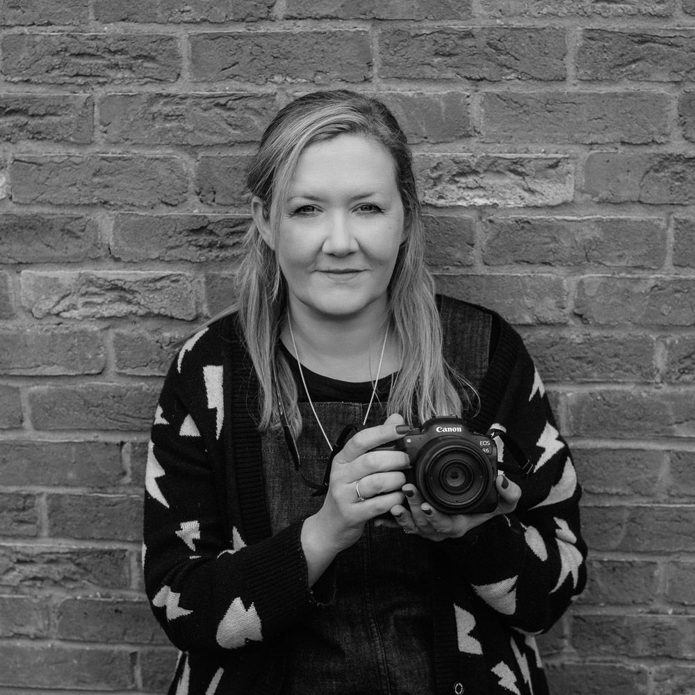 A head shot of Emma Challinor holding her camera.