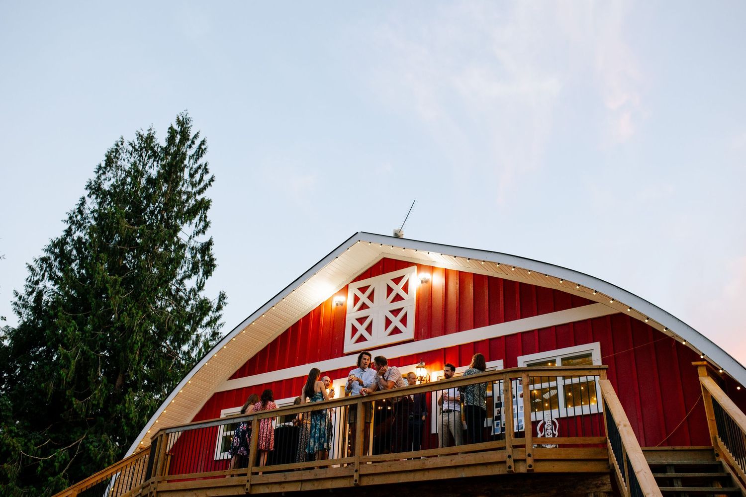 Guests outside barn at Glacier Valley Farm wedding in Squamish, BC.