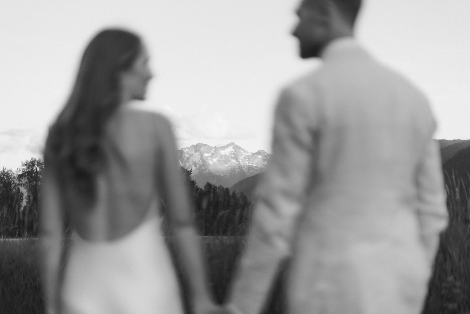 Black and white portrait of couple holding hands.