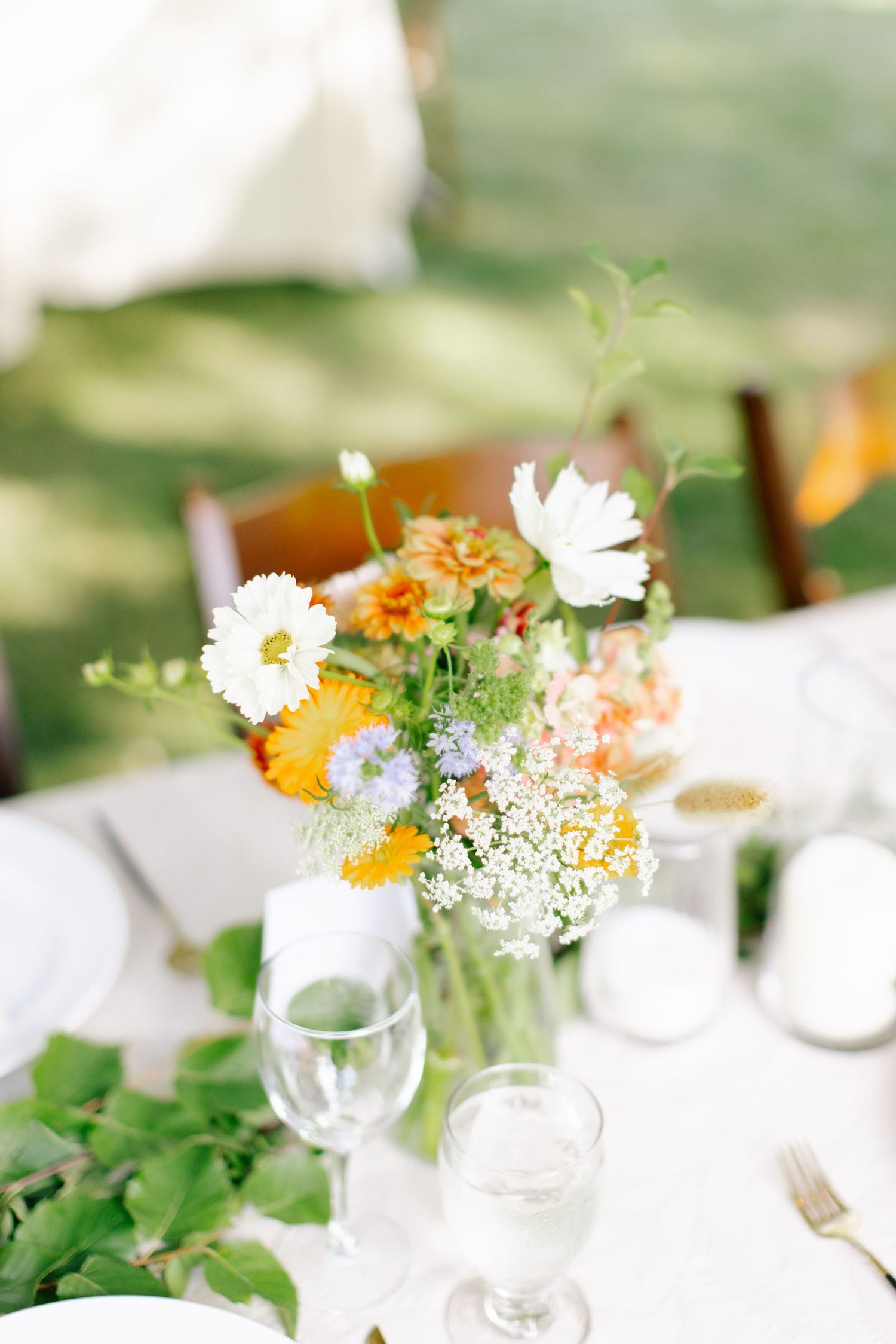 Wedding detail of bouquet and table styling with fresh florals and soft natural light.