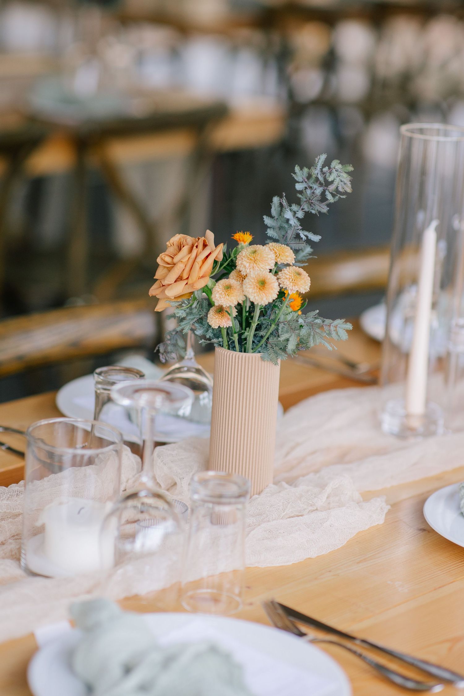 Elegant wedding table detail with glassware and florals.