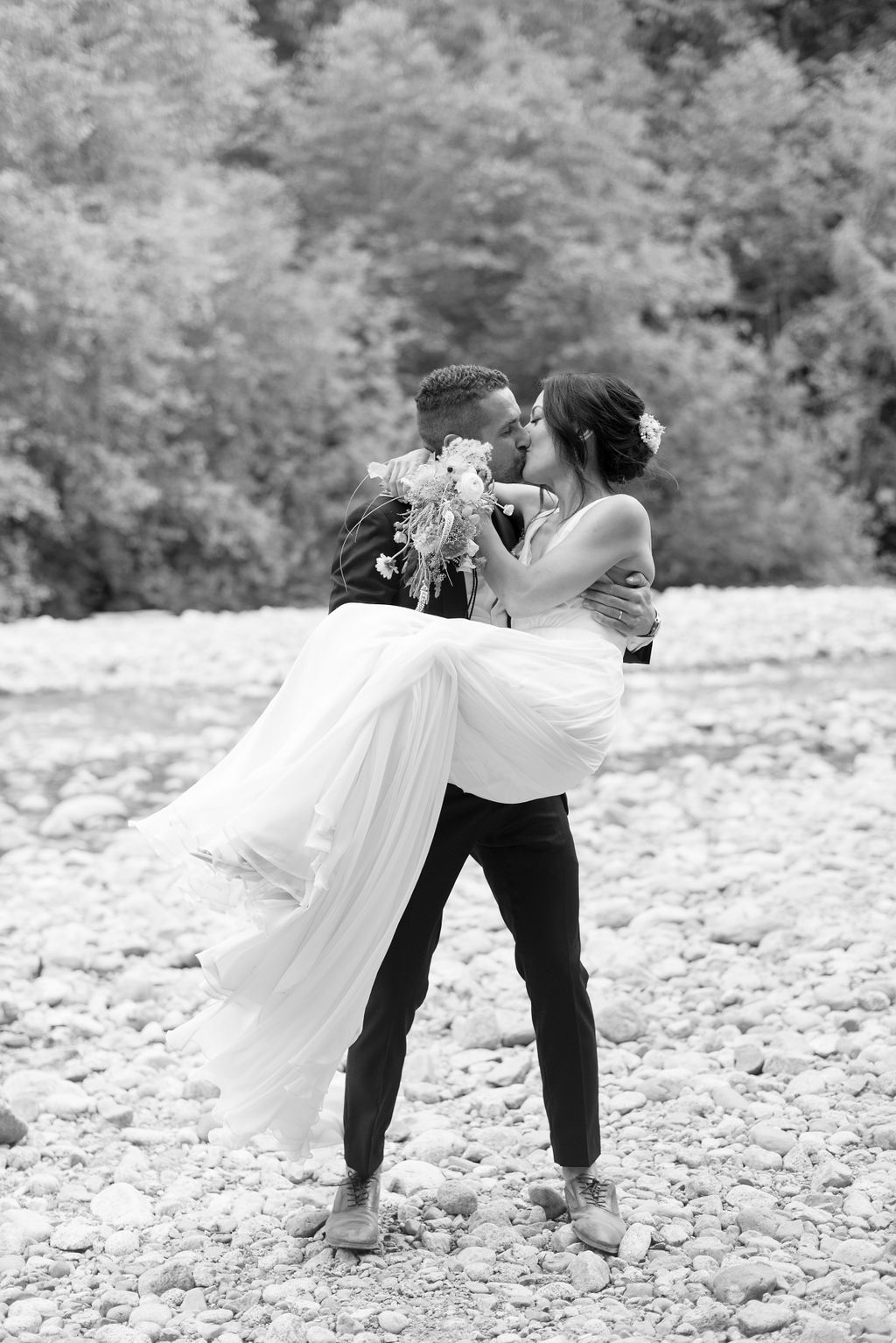 Black and white candid portrait of couple during outdoor session.