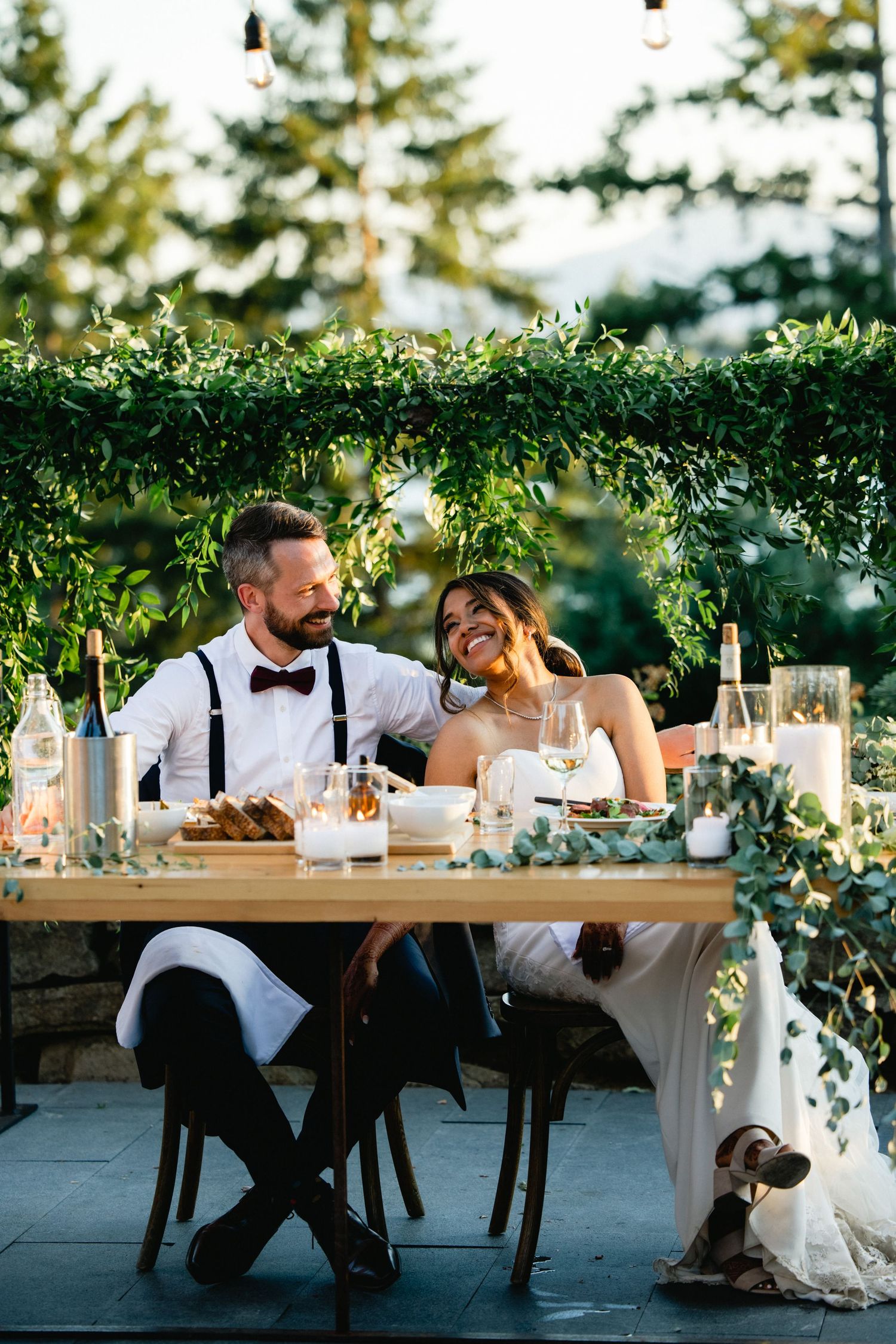 Outdoor reception table set beneath trees.
