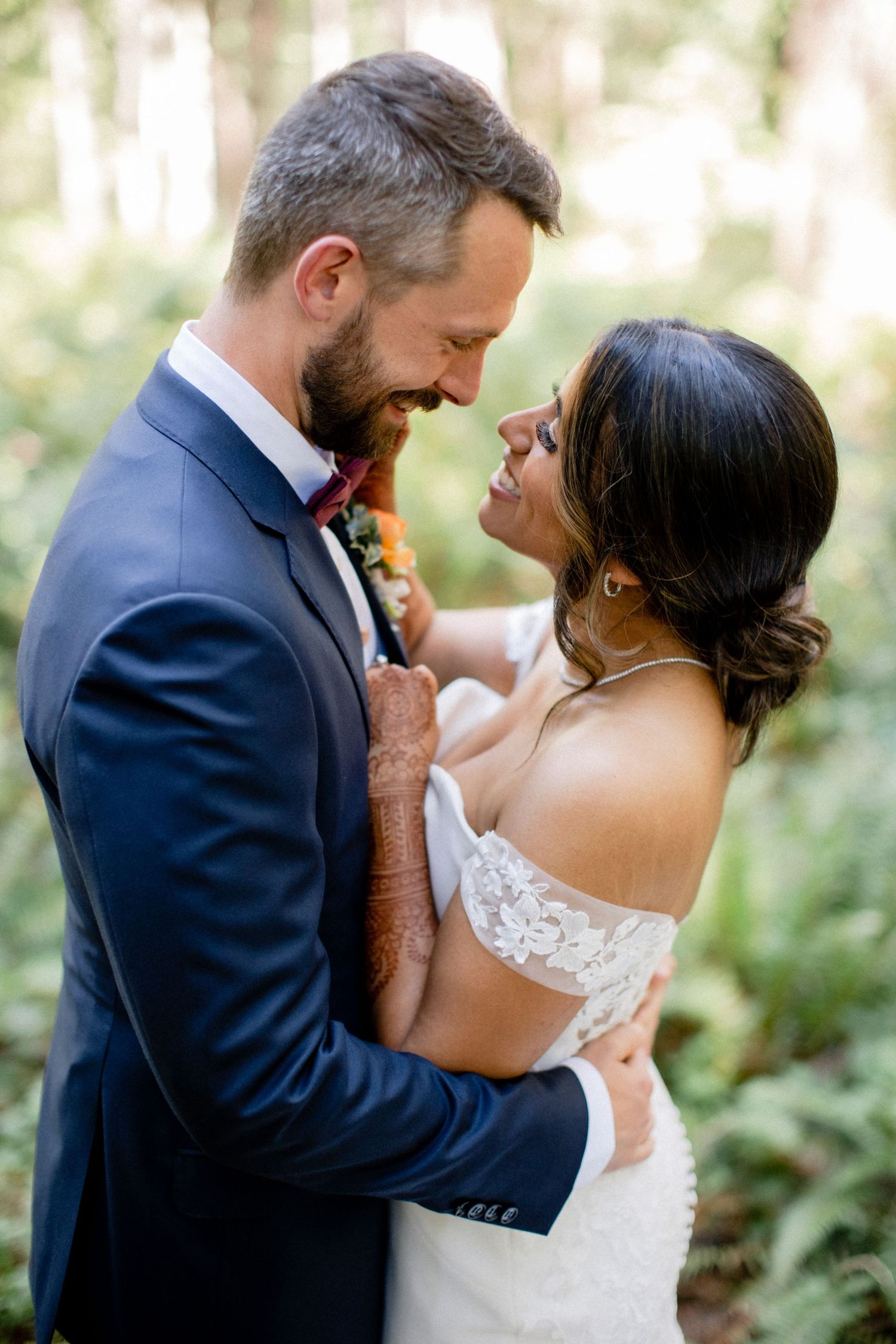 Groom adjusting boutonniere during ceremony.