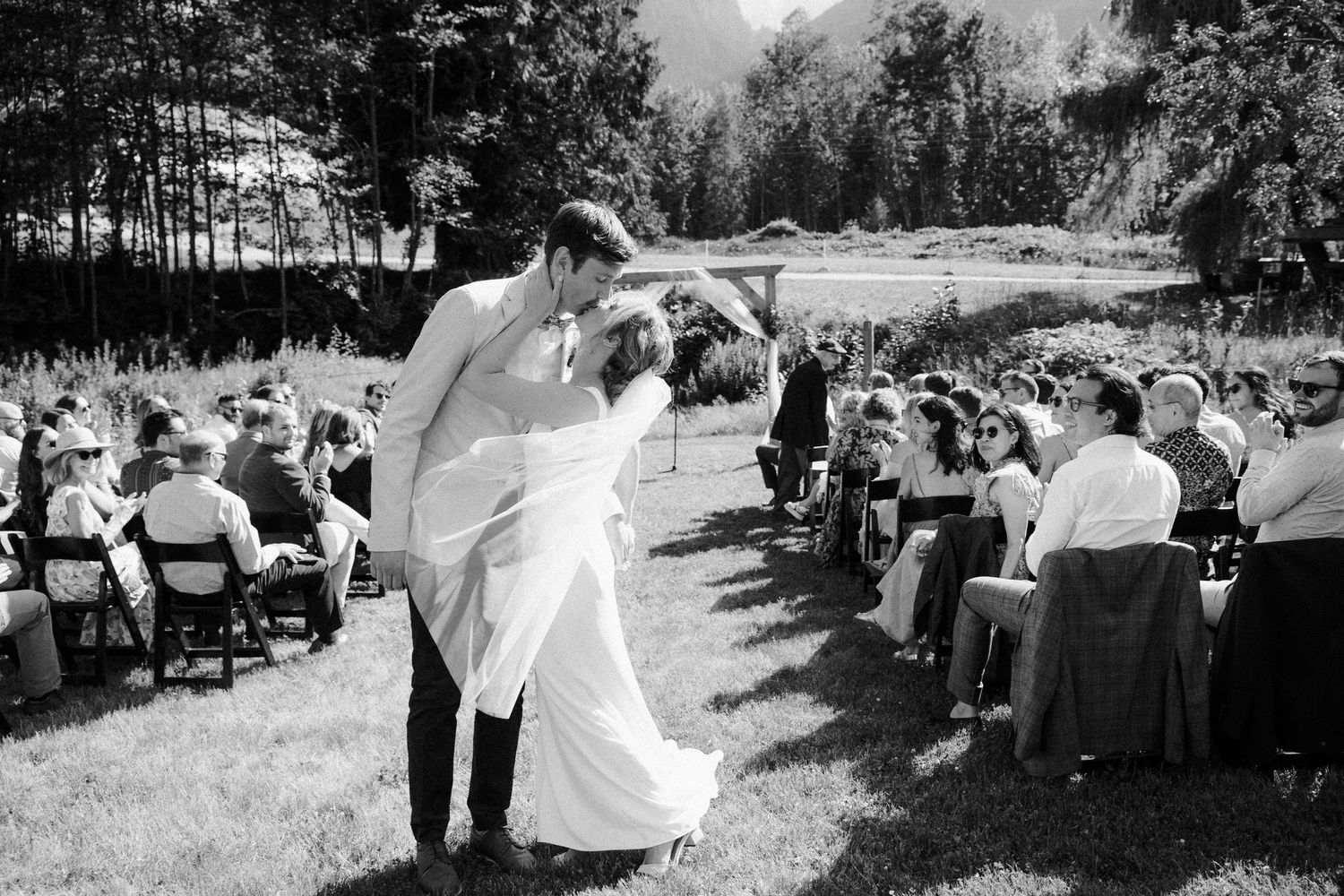Bride and groom kissing at outdoor Squamish wedding.