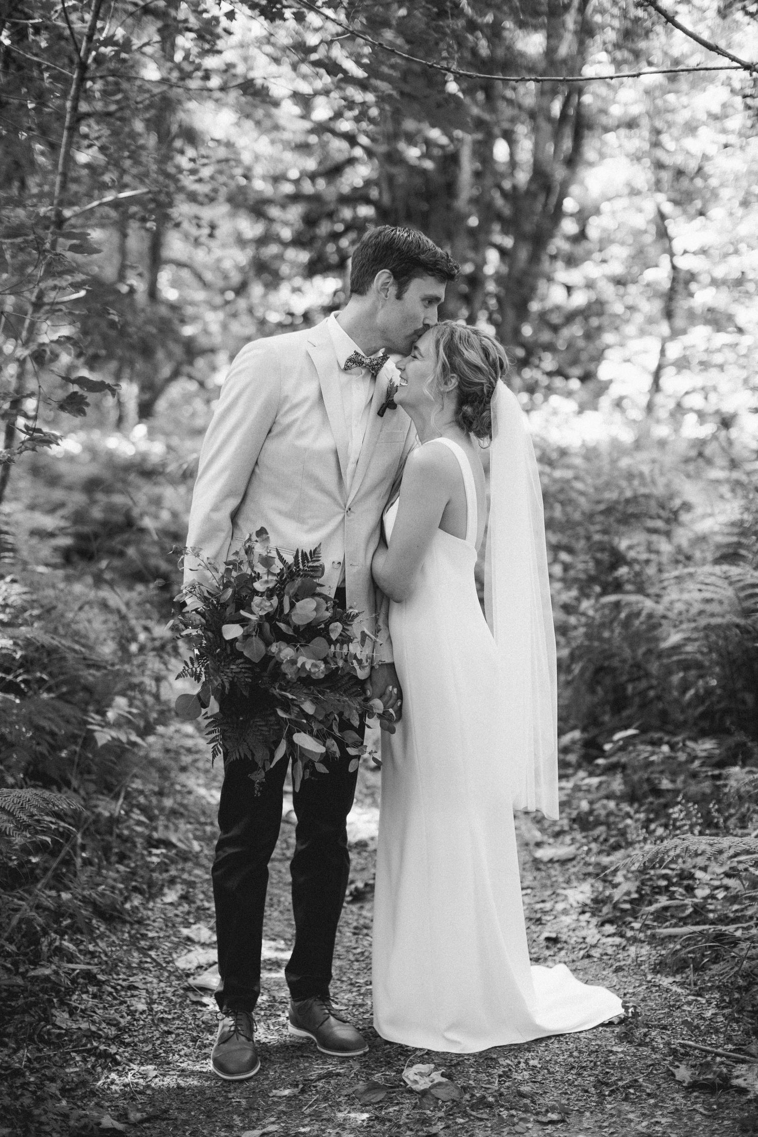 Forehead kisses in the forest.