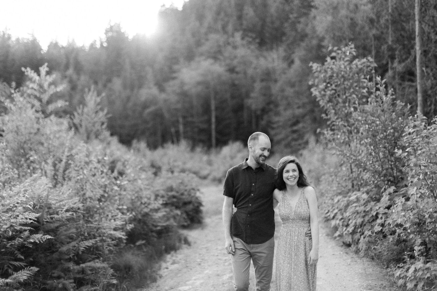 Couple walking down the path at Sunwolf Riverside Resort in Squamish, BC.