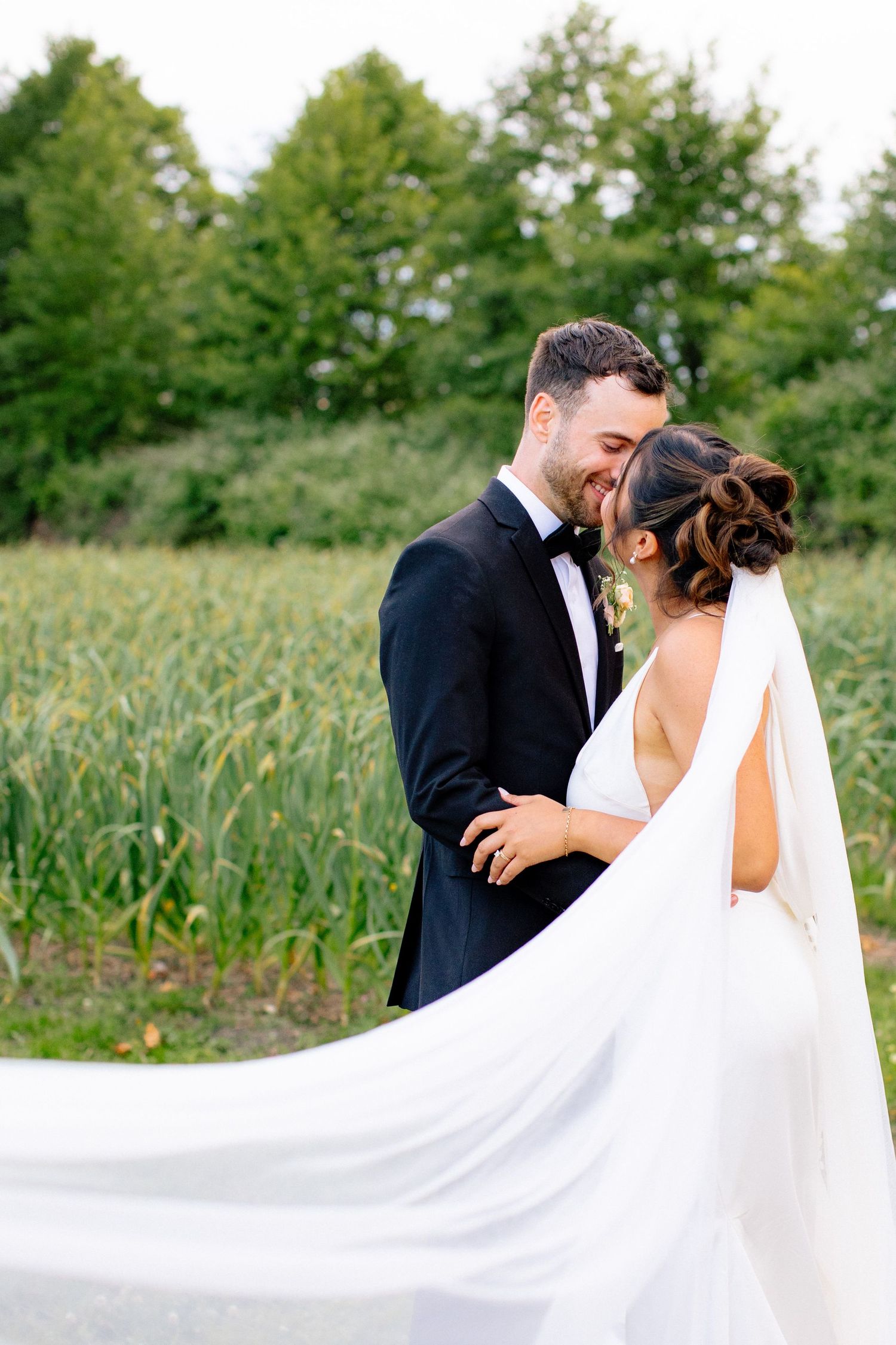 Romantic portrait of couple in tall grass meadow.