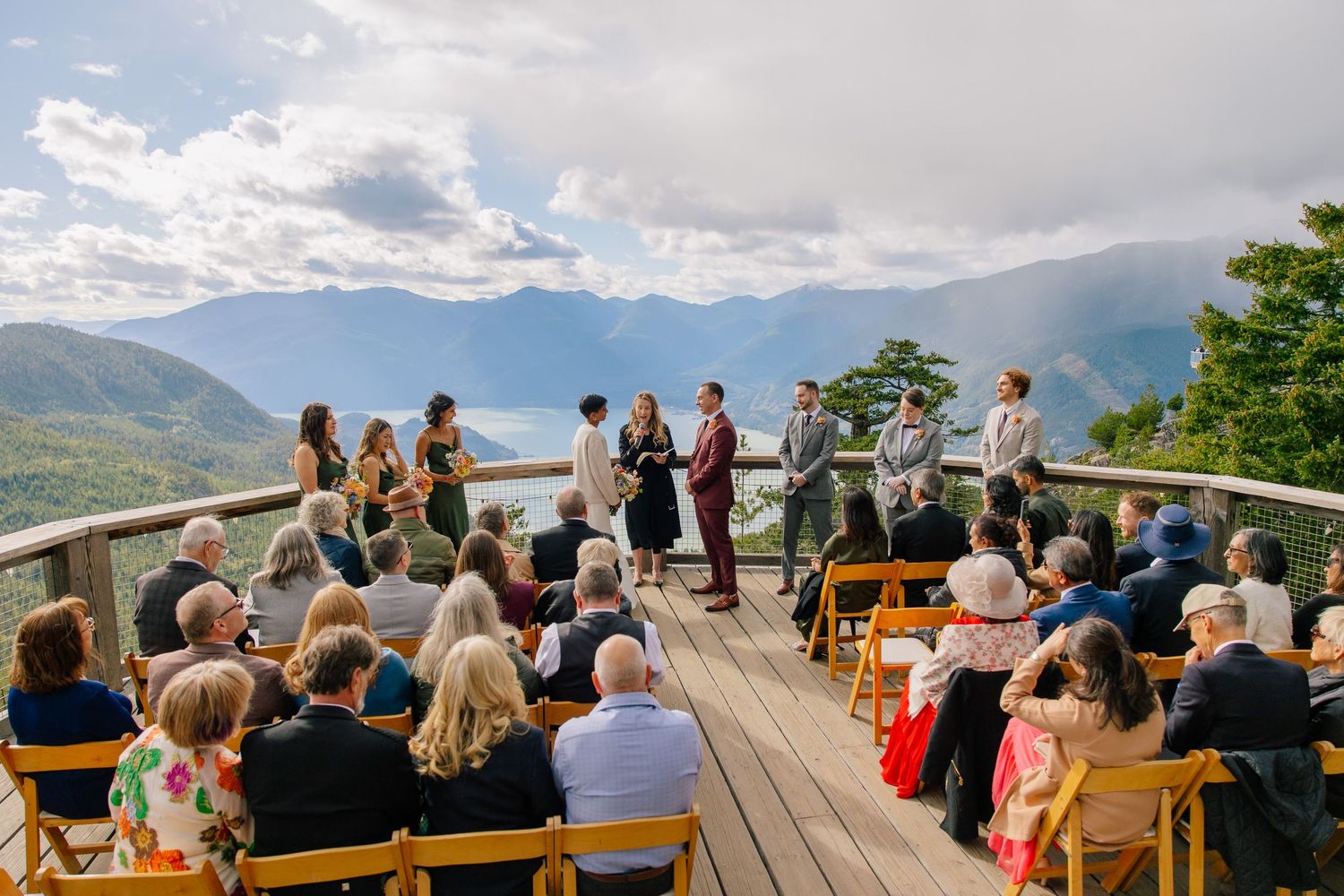 Outdoor wedding ceremony at the Sea to Sky Gondola with guests seated and mountains in the distance.