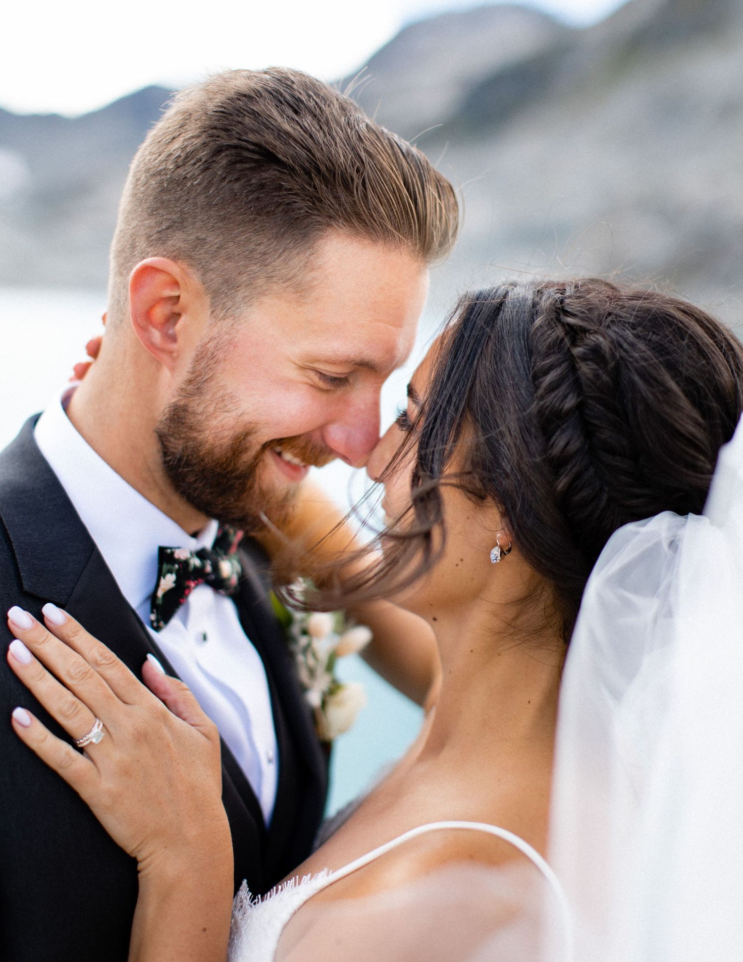 Close-up wedding portrait of bride and groom sharing an intimate moment.