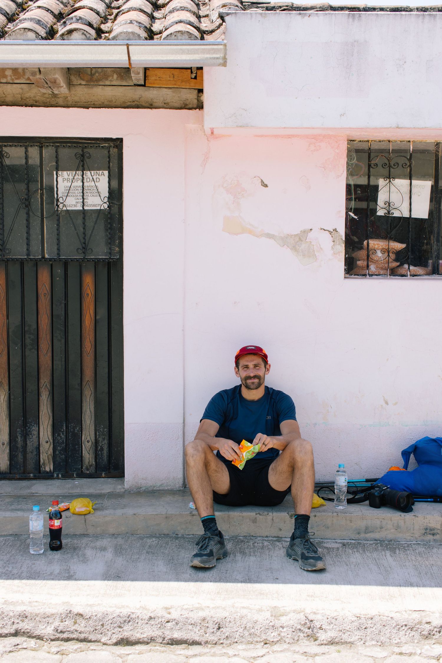 Photographer sitting outside café during travel session.