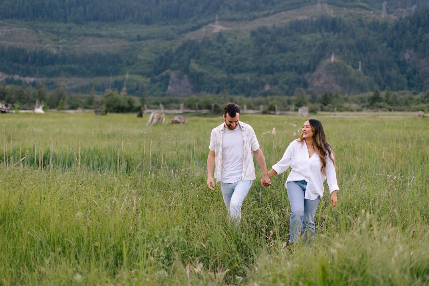 Couple walking through grass in Squamish