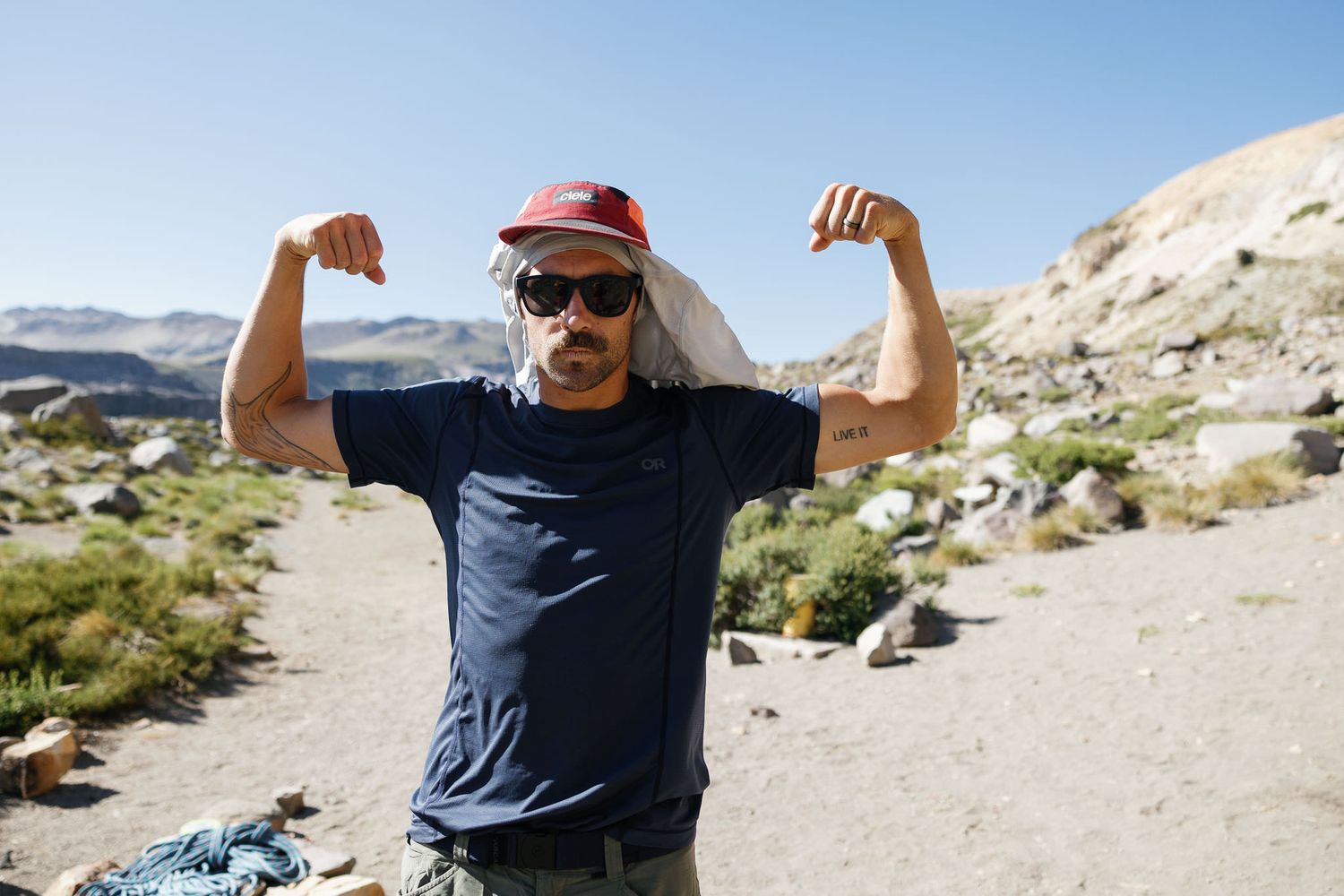Adventure portrait of photographer celebrating on alpine ridge.