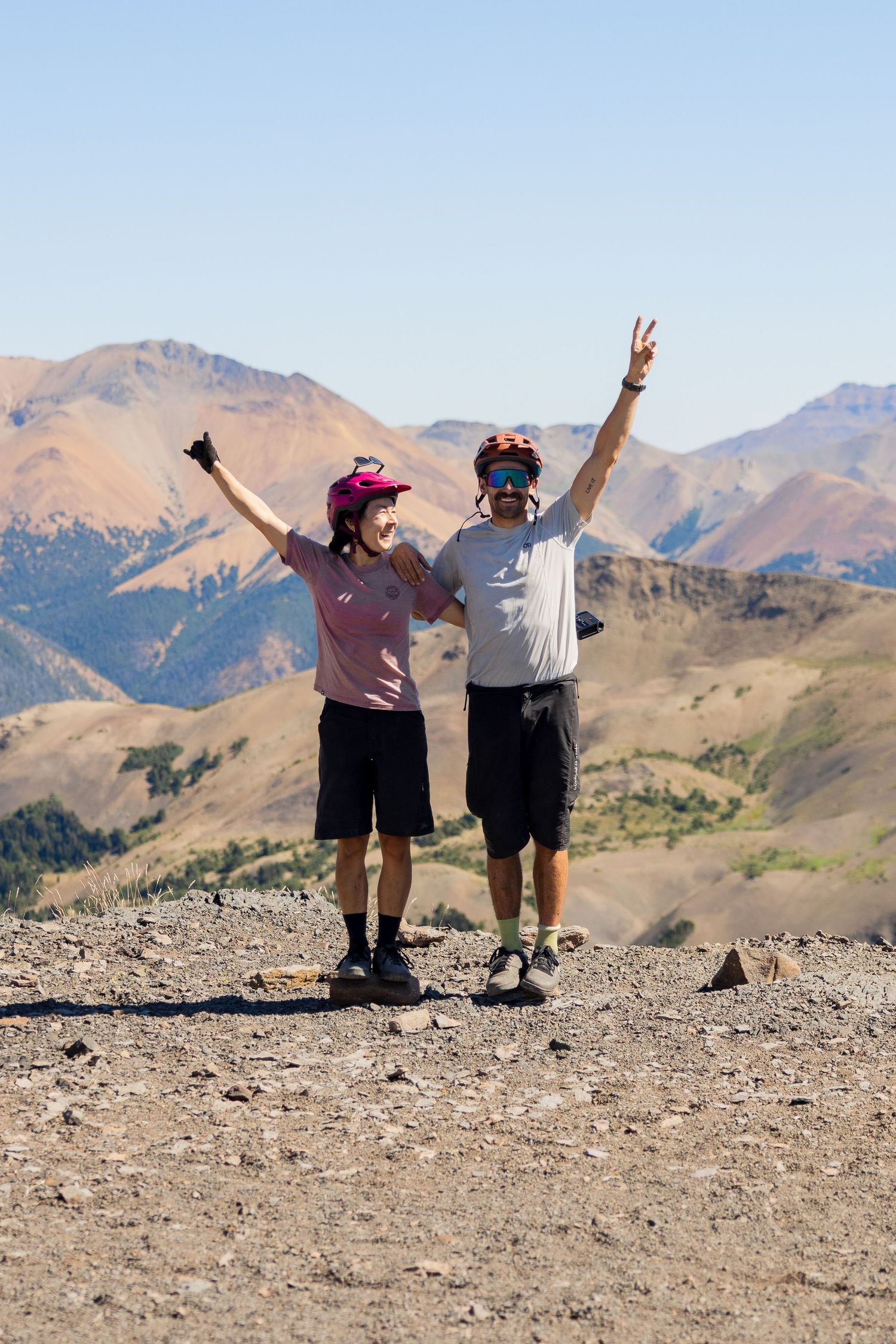 Adventure engagement session in the Chilcotin Mountains with couple celebrating on alpine plateau.