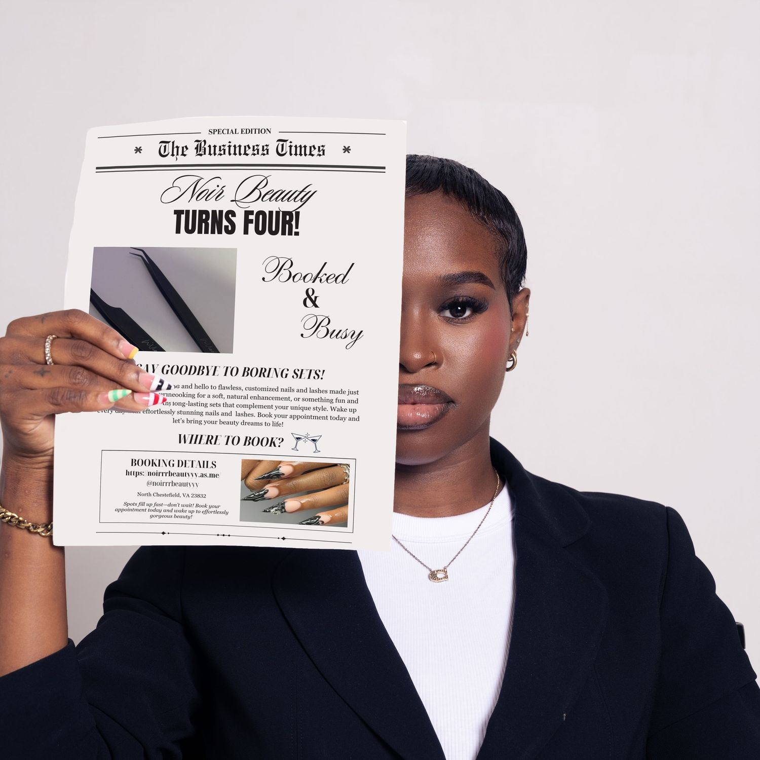 Woman in blazer holding a newspaper reading 'The Business Times: Neo's Beauty Turns Four, Booked & Busy'.