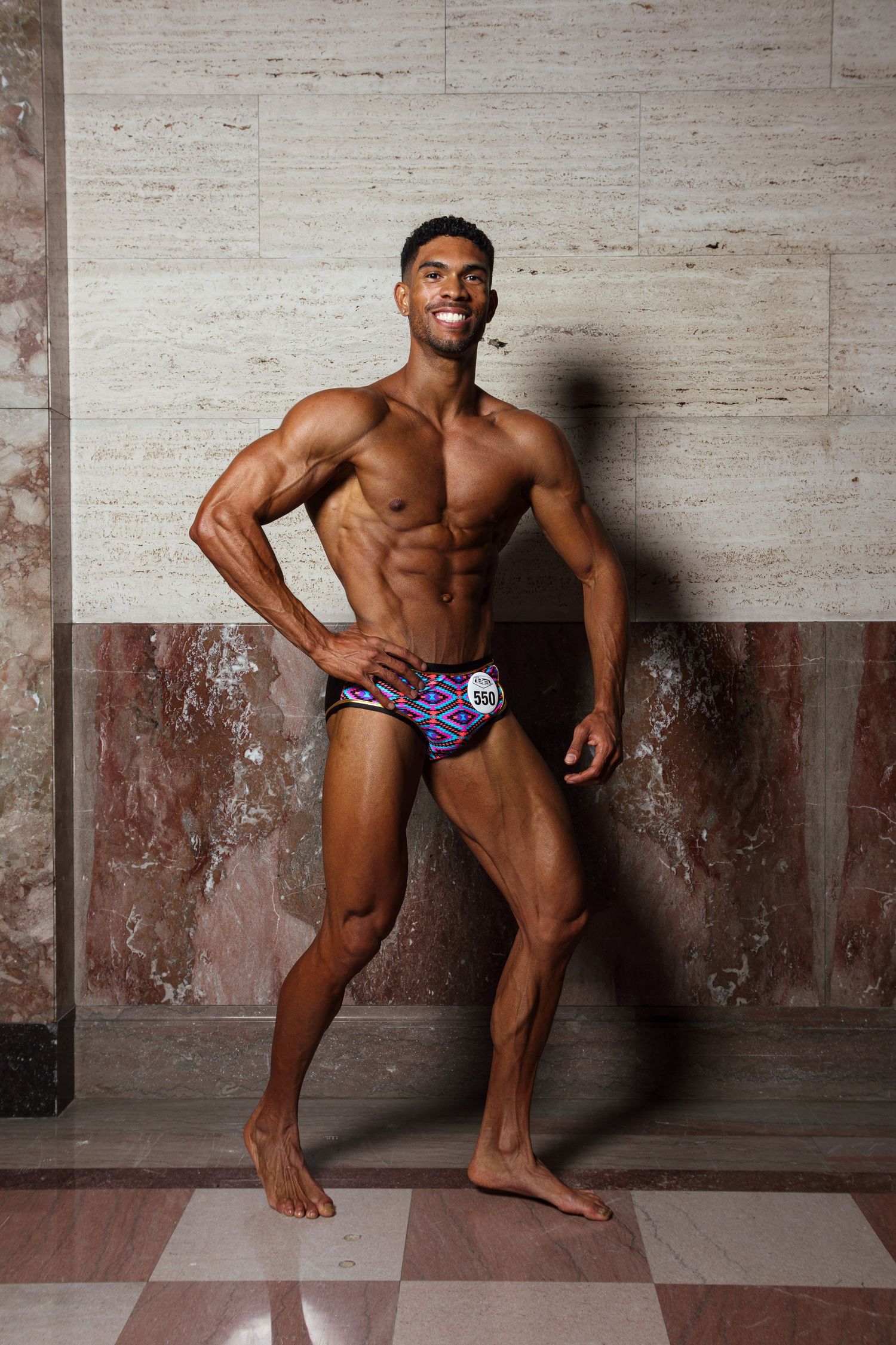Athletic figure striking dynamic poses against a white textured wall.