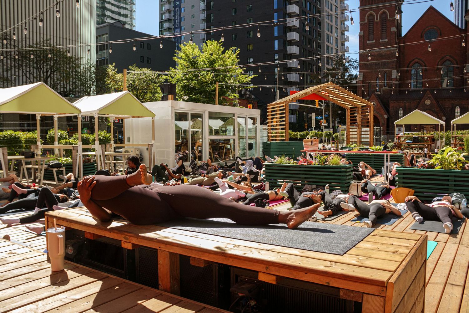 Outdoor patio seating area with umbrellas and tables in an urban setting.