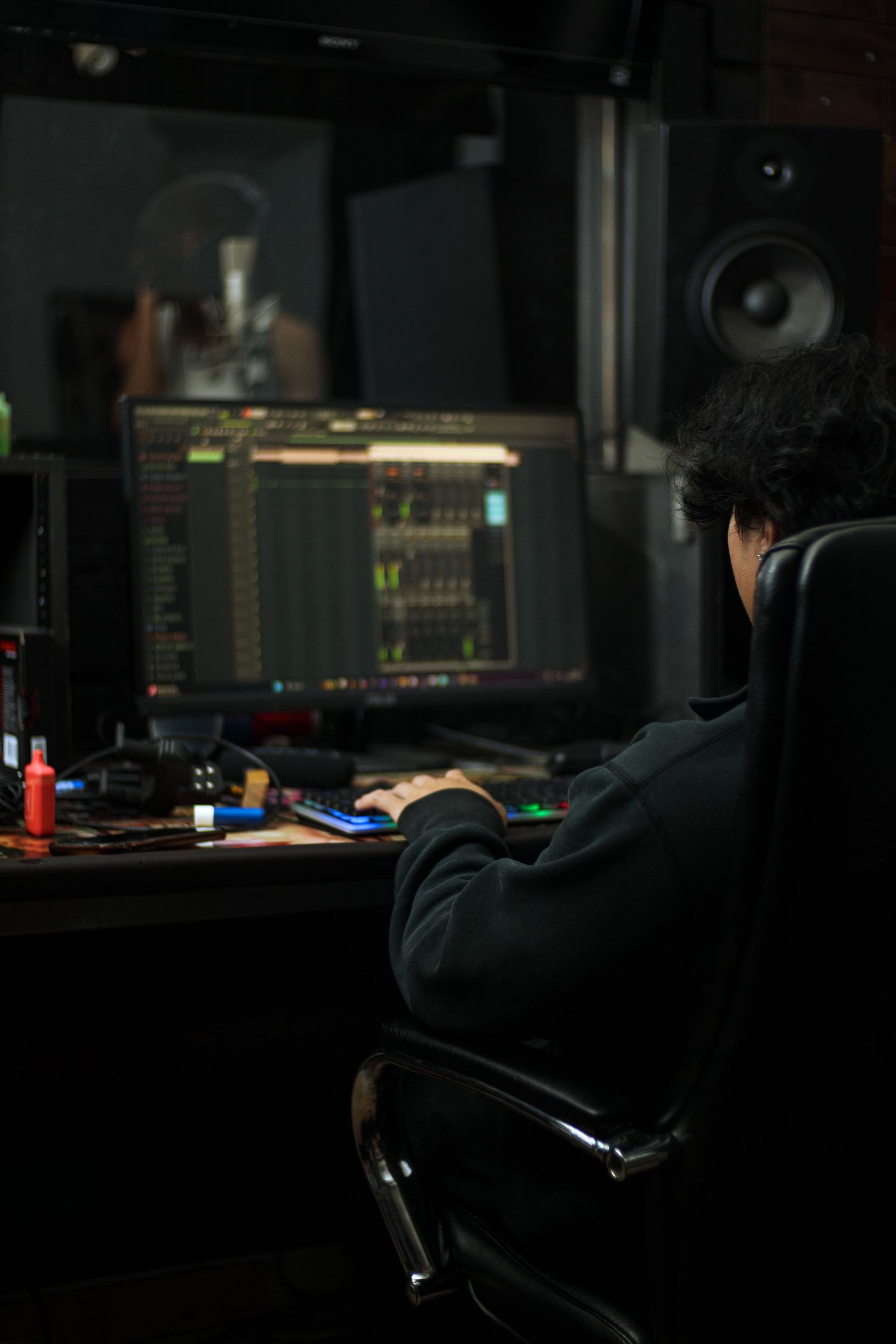 Dark moody shots of recording studio equipment and workspace in low light conditions.