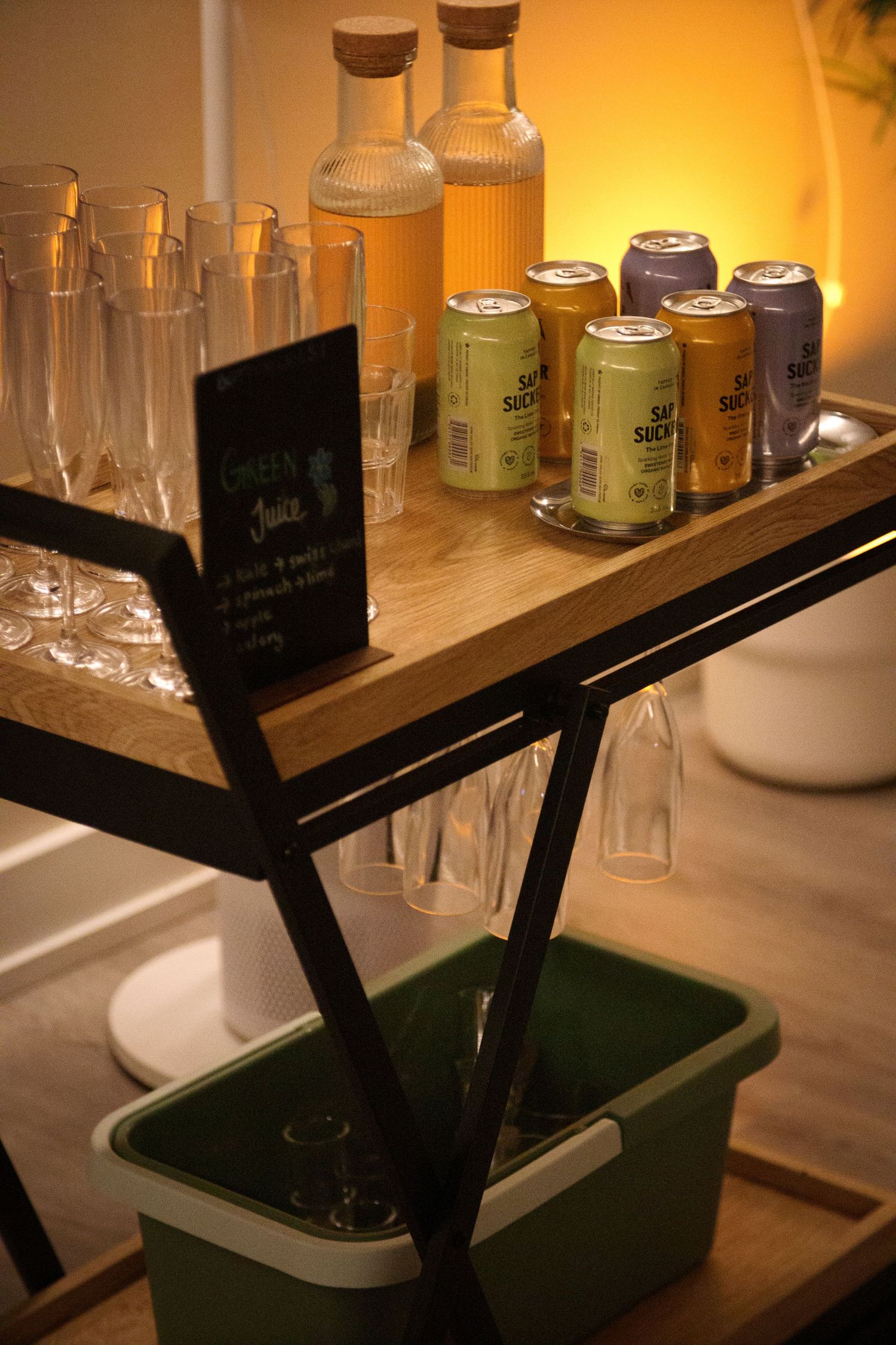 Bar shelf display with various bottles and glasses under warm lighting.