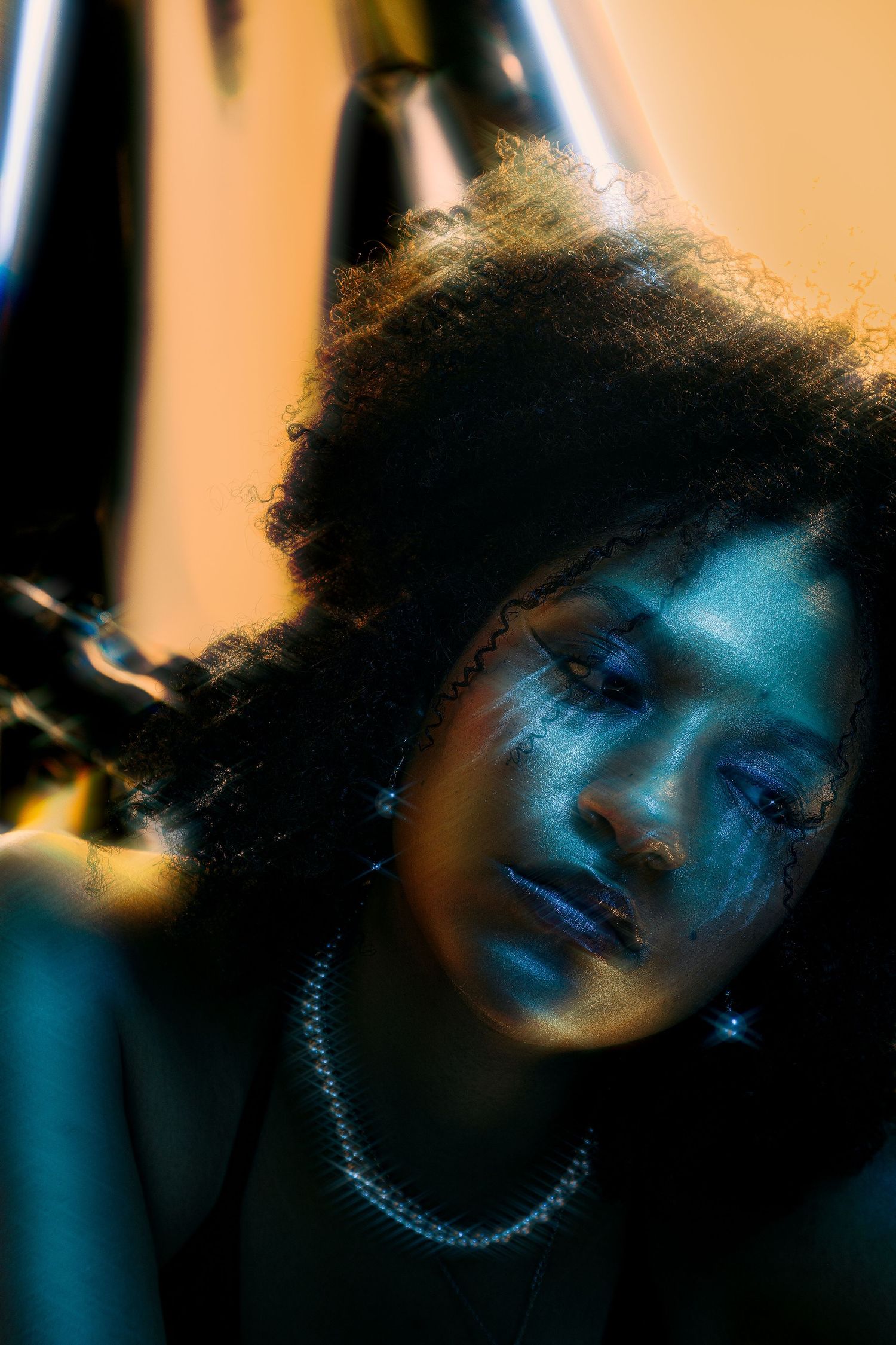 A series of artistic portraits with blue lighting and shadow effects creating a moody atmospheric sequence.