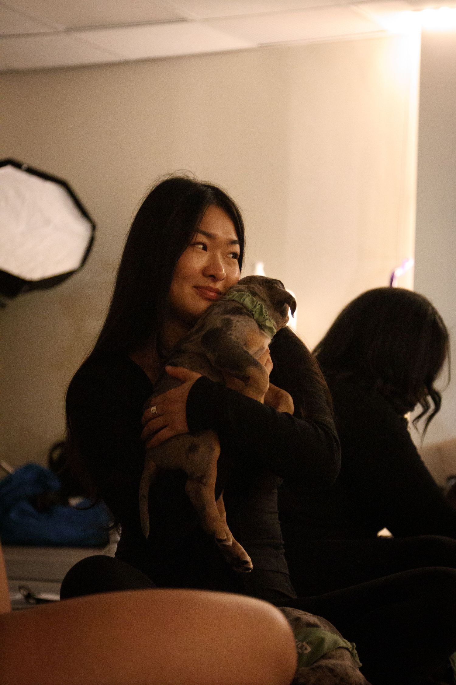 Group relaxing in casual setting under soft lighting.