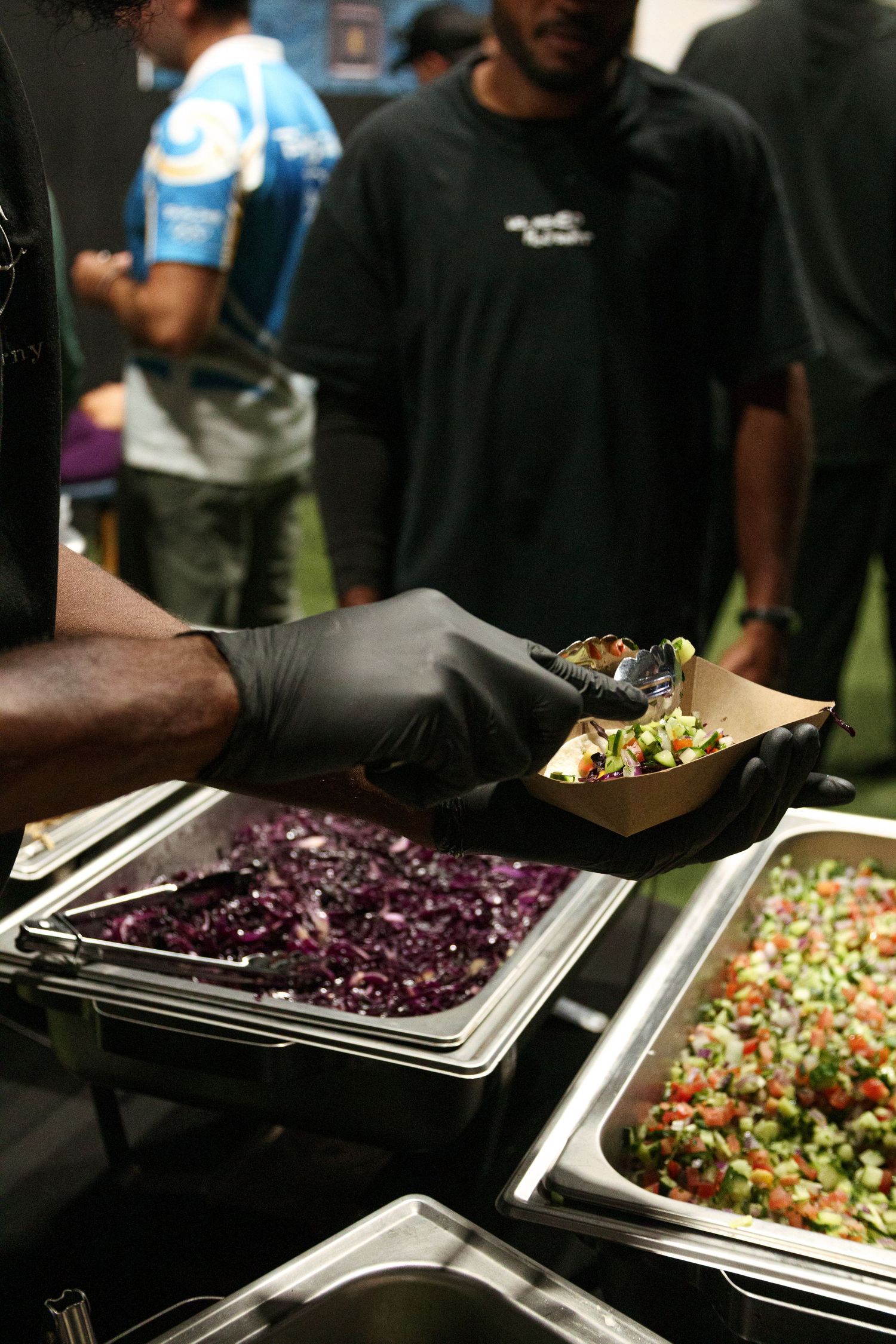 Catering display featuring colorful salads and side dishes on a buffet table.